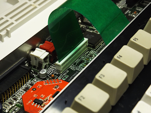 Keyboard connector of Amiga 1200. Keyboard membrane tail connected. Tail clamp unlocked.